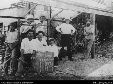 Group at cane carrier, Penang Mill