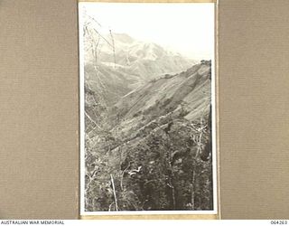 FINISTERRE RANGES, NEW GUINEA.194-01-23. LOOKING DOWN ON THE FARIA VALLEY (FOREGROUND) AND THE RAMU VALLEY (BACKGROUND) FROM THE "PIMPLE" ON SHAGGY RIDGE