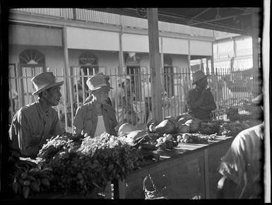 Market scene, elderly men looking at vegetables, Papeete, Tahiti