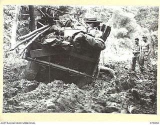 RILE, NEW BRITAIN. 1945-03-15. A TRUCK FROM THE 13TH FIELD COMPANY, ROYAL AUSTRALIAN ENGINEERS, BOGGED IN THE MUD