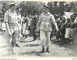 LAE, NEW GUINEA. 1944-09-09. VX13 LIEUTENANT-GENERAL S.G. SAVIGE, CB, CBE, DSO, MC, ED, GOC, NEW GUINEA FORCE INSPECTING NATIVES IN THE MALAHANG COMPOUND