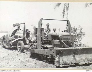 PALMALMAL PLANTATION, NEW BRITAIN. 1944-11-29. HEAVY EARTH MOVING EQUIPMENT OF THE 2/3RD RAILWAY CONSTRUCTION COMPANY, 48TH DEPUTY COMMANDER ROYAL ENGINEERS (WORKS) MOVING FROM THE UNIT CAMP AREA ..