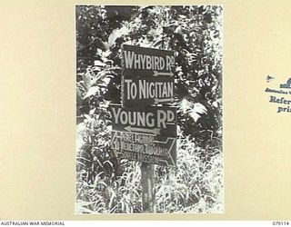 BOUGAINVILLE ISLAND. 1945-02-14. THE SIGNPOST ERECTED AT THE JUNCTION OF THE NIGITAN SOVELE MISSION ROAD AND YOUNG ROAD. NOTE .. NIGITAN SOVELLE MISSION ROAD HAS BEEN RENAMED WHYBIRD ROAD IN HONOUR ..