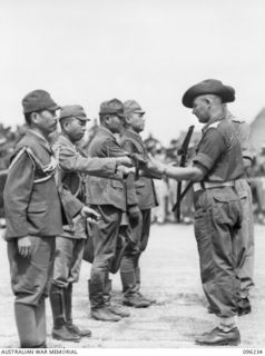 CAPE WOM, NEW GUINEA, 1945-09-13. JAPANESE OFFICERS HANDING THEIR SWORDS TO AN AUSTRALIAN OFFICER OF 6 DIVISION. LT-GEN H. ADACHI, COMD 18 JAPANESE ARMY IN NEW GUINEA, FORMALLY SURRENDERED TO ..