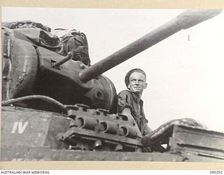 BOUGAINVILLE. 1945-03-30. TROOPER T.J. RYAN LOOKING OUT FROM THE COCKPIT OF A B SQUADRON, 2/4 ARMOURED REGIMENT MATILDA TANK WHICH WAS FLOODED WHEN THE TANK WAS CROSSING THE PURIATA RIVER