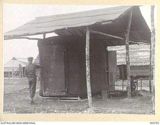 CAPE WOM, WEWAK AREA, NEW GUINEA, 1945-07-02. THE REFRIGERATION UNIT AT 2/22 SUPPLY DEPOT PLATOON. THE UNIT SUPPLIES RATIONS FOR 14,000 TROOPS AND 80 TONS OF FOOD SUPPLIES TO OUT DAILY. IF FURTHER ..