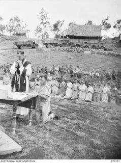 PORT MORESBY, NEW GUINEA. 1944-02-07. WX17091 CHAPLAIN C.W. CUNNINGHAM, MBE., (ROMAN CATHOLIC) (1) CELEBRATING REQUIEM MASS AT THE BOMANA WAR CEMETERY WITH NX45303 PRIVATE J.A. SMITH (2) IN ..