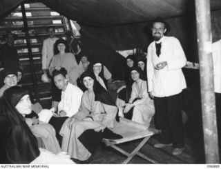 Vunapope, New Britain. Sisters and Priests aboard the Army barge on their way to the motor launch Gloria. they are being evacuated from the Mission in Ramale Valley to Rabaul. Contact with the ..