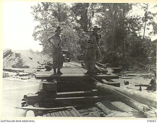 AITAPE, NEW GUINEA. 1944-12-26. PERSONNEL OF THE 2/14TH FIELD COMPANY, USING A SECTION OF A BAILEY BRIDGE TO REPAIR A FLOOD DAMAGED BRIDGE ACROSS THE RIVER EAST OF THE TOWN. IDENTIFIED PERSONNEL ..
