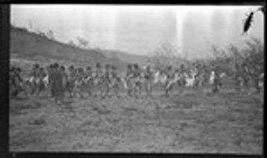 Men of Mambare area dancing in costume, at a gathering