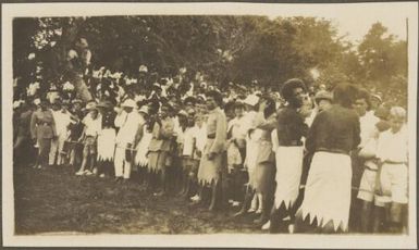 Locals crowd behind a rope cordon waiting for Charles Kingsford-Smith to land, Fiji, June 1928