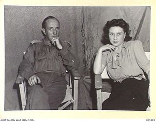 TOROKINA, BOUGAINVILLE, 1945-08-16. LIEUTENANT D.W. MARTIN, PHOTOGRAPHER, 3 MILITARY HISTORY FIELD TEAM ATTACHED HEADQUARTERS 3 DIVISION SPEAKING WITH MISS PEGGY SHEA A MEMBER OF THE GRACIE FIELDS ..