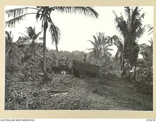 JACQUINOT BAY, NEW BRITAIN. 1944-11-04. PERSONNEL OF THE 55TH FIELD PARK COMPANY MECHANICAL EQUIPMENT PLATOON, 12TH FIELD COMPANY, OPERATING BULLDOZERS DURING THE BUILDING OF A ROAD NEAR THE CAMP ..