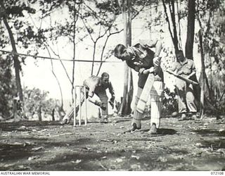 LAKONA, NEW GUINEA. 1944-04-05. PERSONNEL AT HEADQUARTERS 5TH DIVISION USING SPORTING GEAR PROVIDED BY THE ARMY AMENITIES SERVICE. THE PACIFIC OCEAN APPEARS FAINTLY AT THE BACKGROUND. IDENTIFIED ..