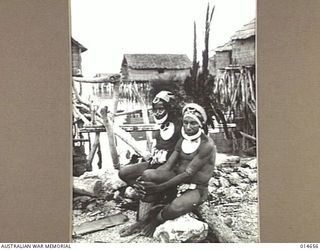 1943-04-14. NEW GUINEA. A HEADDRESS MADE OF BRIGHTLY HUED FEATHERS AND A "COLLAR" OF SHELLS WAS WORN BY THOSE TWO SUB CHIEFS OF THE CHIMBU TRIBE WHO CAME DOWN FROM THE INTERIOR OF NEW GUINEA TO ..