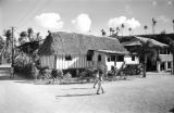 Guam, boys walking through village