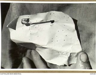 FORBES, AUSTRALIA. 1943-02. CLOSE-UP OF A DETECTOR WORN ON THE SHOULDER OF A "GUINEA PIG" IN A GAS SHELL EXPERIMENT. STAINS ARE OF APPROXIMATE DIAMETER 0.75 MM CORRESPONDING TO DROPS OF DIAMETER ..