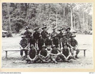 Group portrait of members of 2 Platoon, Headquarters Company, 58/59 Infantry Battalion. Identified, back row, left to right: Private (Pte) K Crutchfield; Pte G Whitehead; Pte W Kerr; Pte A Danks; ..