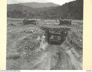 WAMPIT, NEW GUINEA, 1944-03-01. A TRUCK BEING LOADED WITH GRAVEL AT A PIT SIXTY TWO AND A QUARTER MILES FROM LAE BY MEMBERS OF HEADQUARTERS, COMMANDER ROYAL ENGINEERS (A.I.F.). A "CHINAMAN" HAS ..