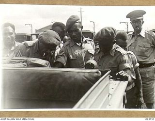 1944-01-26. AUSTRALIAN AND NEW GUINEA ADMINISTRATION UNIT NATIVES INSPECTING A NEW AMPHIBIOUS JEEP AT THE FACTORY OF THE FORD MOTOR COMPANY