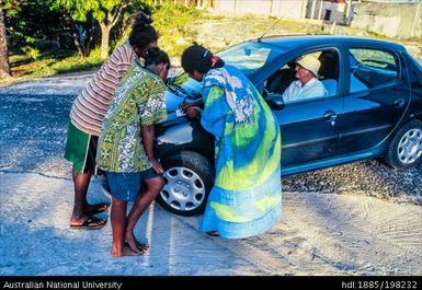 New Caledonia - Ouvéa - three Kanaks around a black car