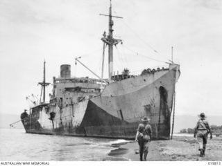 1943-09-25. NEW GUINEA. FALL OF LAE. THE WRECKED JAPANESE SHIP MYOKO MARU AGROUND ON A BEACH NEAR LAE