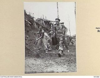 BERRY'S HILL, CENTRAL BOUGAINVILLE, 1945-06-27. TROOPS OF 7 INFANTRY BATTALION CONSTRUCTED A ROAD ON BERRY'S HILL TO ENABLE SUPPLIES TO BE EXPEDITED UP TO FORWARD TROOPS. SHOWN, PTE W.E. JACKSON, ..