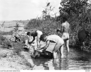 BABIANG, NEW GUINEA. 1944-11-06. MEMBERS OF A TROOPS, 2/10 COMMANDO SQUADRON CLEANING UP AFTER A PATROL INTO JAPANESE TERRITORY NEAR THE DANMAP RIVER. IDENTIFIED PERSONNEL ARE:- TROOPER L. ..