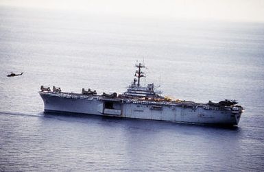 A port beam view of the amphibious assault ship USS GUAM (LPH-9) during flight operations off the coast of Beirut, Lebanon