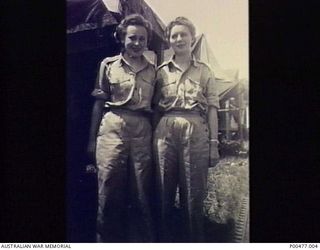 LAE, NEW GUINEA. WW2. SISTER COLLEEN RYAN (R) AND SISTER MOLLY GOBBARD (L) OF THE FIRST MEDICAL AIR EVACUATION TRANSPORT UNIT (NO. 1 MAETU) IN TROPICAL UNIFORM