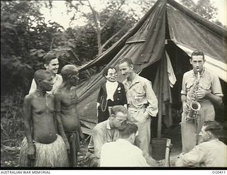 KIRIWINA, TROBRIAND ISLANDS, PAPUA. C. 1943-11-12. LEADING AIRCRAFTMAN W. EDMUNDS OF NORWOOD, SA, AN ORDERLY ROOM CLERK WITH HIS DOLL "HENRY". HE IS A VENTRILOQUIST AND HAS APPEARED AT MANY RAAF ..