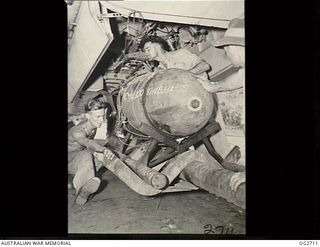 VIVIGANI, GOODENOUGH ISLAND, PAPUA. 1943-11-17. ARMOURERS LOADING A 2000LB DAISY-CUTTER BOMB INTO A BEAUFORT BOMBER AIRCRAFT OF NO. 8 SQUADRON RAAF COMMANDED BY WING COMMANDER G. D. NICOLL IN ..