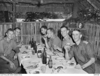 RABAUL, NEW BRITAIN, 1945-12-25. OFFICERS OF 2/4TH ARMOURED REGIMENT ENJOYING THEIR CHRISTMAS DINNER