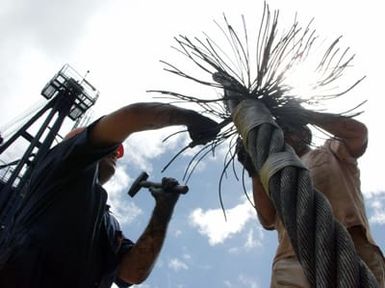 Contract Steel workers onboard the Bahamian, Multi-purpose Diving Support Vessel (DSV) "Rockwater 2" prepare a steel cable that will serve as a leading wire used to hoist the Ehime Maru off of the sea floor during recovery operations