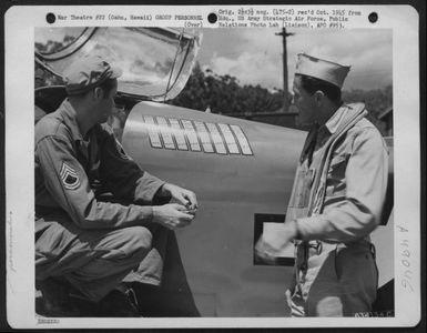 T/Sgt. Cletus Johnson Of 66 East Hubbard Ave., Columbus, Ohio And Capt. James V. Smith Of 1465 Gaylord St., Denver, Colo. (Left To Right) Discuss The 'Combat' Stripes On A Culver Pq-8A 'Red Fox', A Radio Controlled Plane. Wheeler Field, Oahu, Hawaii, Apri (U.S. Air Force Number 63413AC)