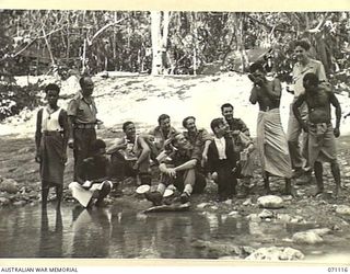 KILIGIA, NEW GUINEA, 1944-03-15. MEMBERS OF THE 3RD ARMOURED DIVISION CONCERT PARTY REHEARSING LINES ON THE BANKS OF THE CREEK AT WHICH THEY ARE CAMPED. TROOPER BAILEY IS AMUSING AUSTRALIAN NEW ..