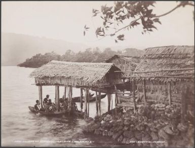 People in canoes at the food houses of Adegege, Malaita, Solomon Islands, 1906 / J.W. Beattie