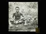 Man removing coconut flesh, New Guinea?, c1924 to ?