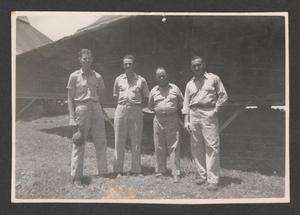 [Four Soldiers Posing for Photo at Camp]