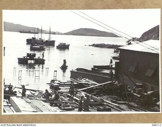 NAPA NAPA, NEW GUINEA. 1943-11-12. GENERAL VIEW OF THE 2ND AUSTRALIAN WATERCRAFT WORKSHOPS, AUSTRALIAN ELECTRICAL AND MECHANICAL ENGINEERS SHOWING SHIPS WAITING TO BE REPAIRED OR UNDERGOING REFITS. ..