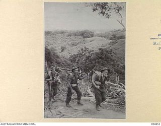 ILIPEM, NEW GUINEA, 1945-07-31. MEMBERS OF NO. 10 PLATOON, B COMPANY, 2/5 INFANTRY BATTALION, MOVING UP THE ILIPEM TRACK TO TAKE UP A NEW FORWARD POSITION
