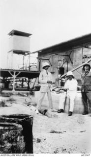 Colonel William Holmes, Commander of the Australian Naval and Military Expeditionary Force (AN&MEF) (in centre) and two unidentified officers at the wireless station at Bitapaka after its capture.  ..