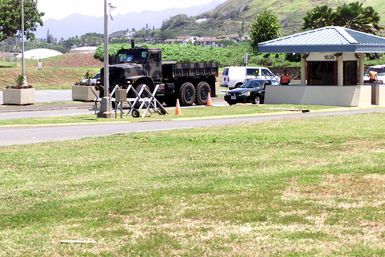 A partially obstructed view of the Medium Tactical Vehicle Replacement (MTVR) seven-ton tactical vehicle arriving at Marine Corps Base (MCB), Kaneohe, Hawaii. The MTVR will replace the existing medium tactical motor transport fleet of M809/M939 series trucks and is a cost-effective state of the art technologically improved truck