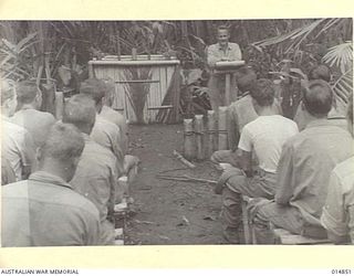 1943-05-17. NEW GUINEA. GONA. JUNGLE CHAPEL USED BY AN AMERICAN INFANTRY SECTION AT GONA. PICTURE SHOWS CAHPLAIN MARCUS W. JOHNSON OF NORFOLK, NEBRASKA, CONDUCTING THE SERVICE. (NEGATIVE BY N. ..