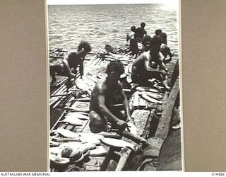 1943-04-05. NEW GUINEA. SAILING THEIR OWN LUGGERS AND LAKOTOIS THESE PAPUAN NATIVES CATCH FISH TO VARY THE DIET OF ALLIED TROOPS AND THOSE IN HOSPITAL. THE NATIVES DIVE IN AND SWIM WITH HAND NETS ..