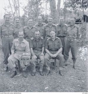 GUSIKA, NEW GUINEA. 1944-03-17. OFFICERS OF THE 1ST TANK BATTALION, ON THE WAREO TRACK. LEFT TO RIGHT: FRONT ROW: NX564 MAJOR E. J. RYRIE, WITH NATIVE MASK; NX113774 LIEUTENANT COLONEL E. A. ..