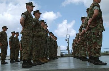 On board US Navy (USN) Amphibious Command Ship USS BLUE RIDGE (LCC 19), US Marine Corps (USMC) Marines of the 7th Fleet, Fleet Anti-Terrorist Security Team (FAST) stand ready to be inspected at US Naval Forces Marianas, Guam. The BLUE RIDGE is here to participate in Exercise TANDEM THRUST 2003