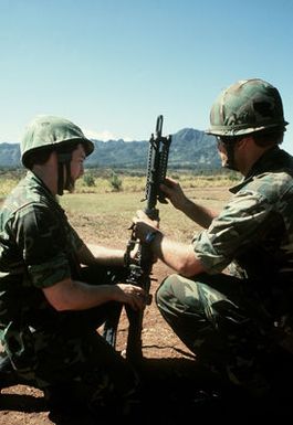 SSGT Miller and SGT Lindland, members of the combat control team (CCT), set up the M-60 machine gun