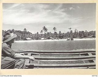 MUSCHU ISLAND, NEW GUINEA. 1945-10-10. THE BEACH HEAD AT MUSCHU AS SEEN FROM AN APPROACHING AUSTRALIAN BARGE. HOSPITAL WARDS AND BUILDINGS CAN BE CLEARLY SEEN ERECTED AT THE REAR OF THE SAND. ..