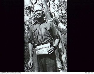 FRENCH'S FOREST, NSW, 1942-10. TWO MEMBERS OF 9TH AUSTRALIAN FIELD AMBULANCE, 2ND AIF, FERRYING A THIRD MEMBER, "A CASUALTY," ACROSS A CREEK DURING MANOEUVRES. (DONOR T. KELLY)